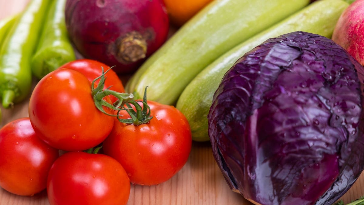 A vibrant assortment of fresh, organic vegetables on a wooden table, perfect for healthy eating.